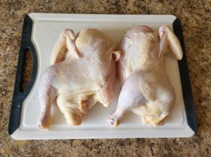 preparing the two whole chickens to make Huli Huli chicken