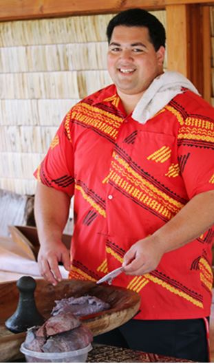 Volunteer Spencer Mauai helps make fresh poi in the PCC’s Hawaiian Village