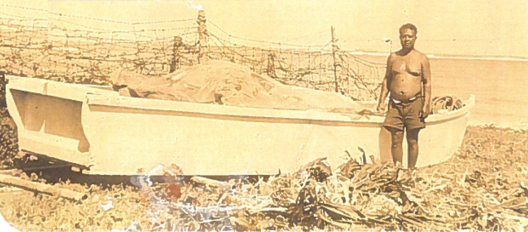Moses Hiram with his fishing boat in front of the barbed wire barricades - Photo courtesy of Laverne Pukahi