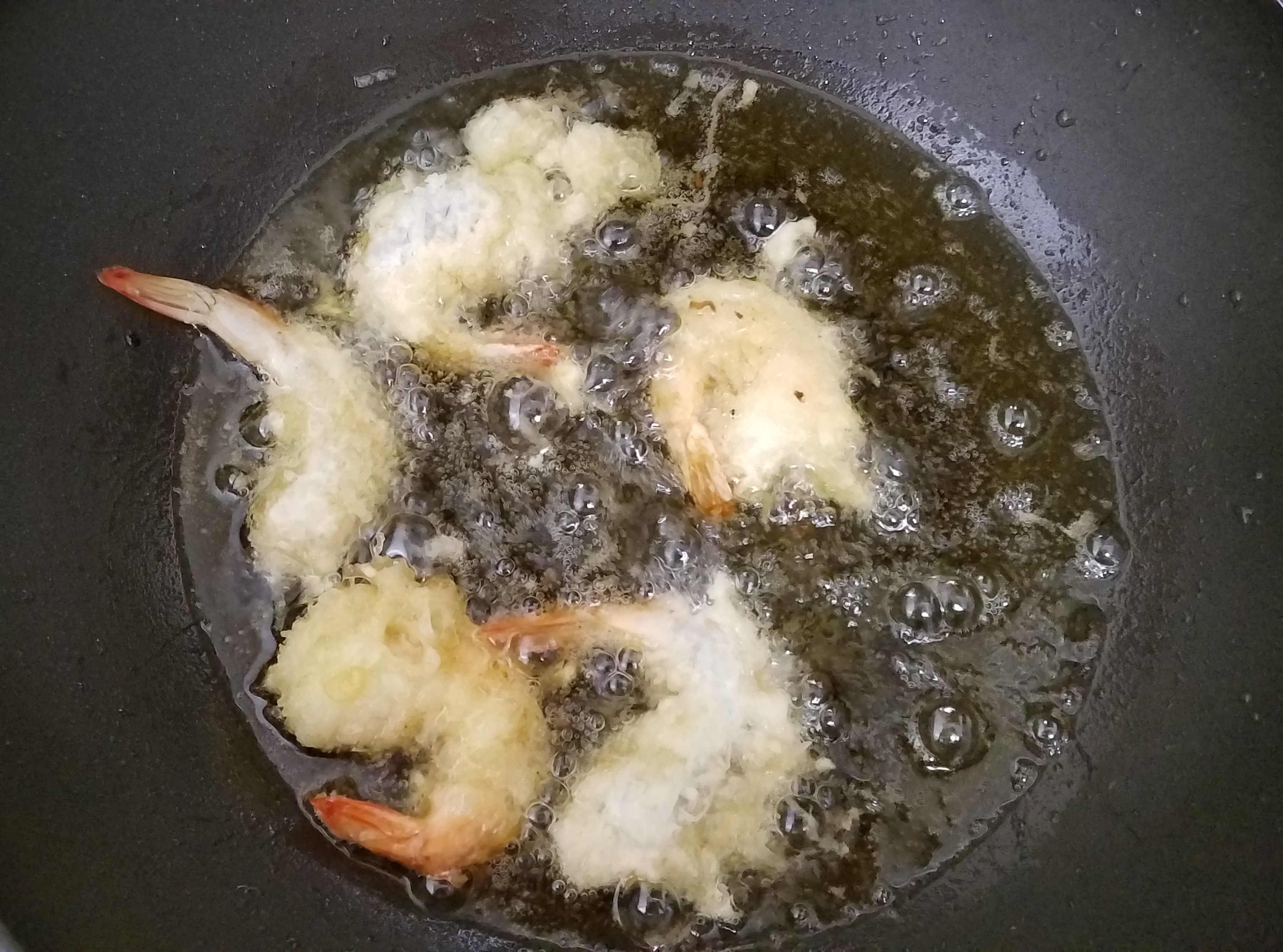 photo showing battered shrimp frying for Coconut Shrimp recipe