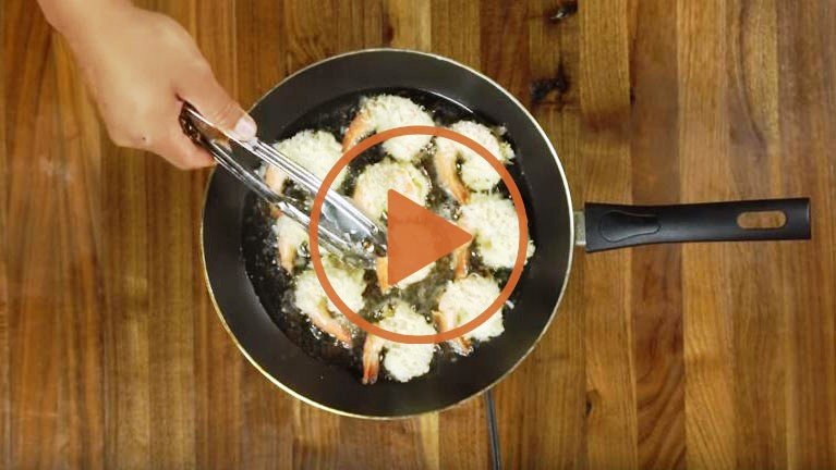 photo of coconut shrimp in fry pan with play button
