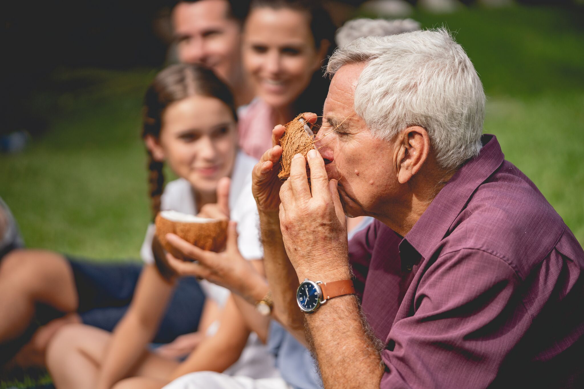 picture of man drinking from a coconut during the hands-on cooking experience at the Polynesian Cultural Center