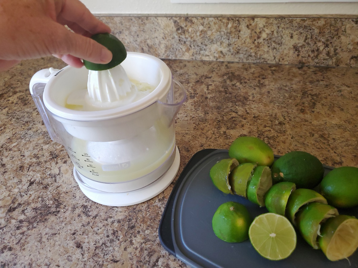 Photograph of woman using an electric juicer