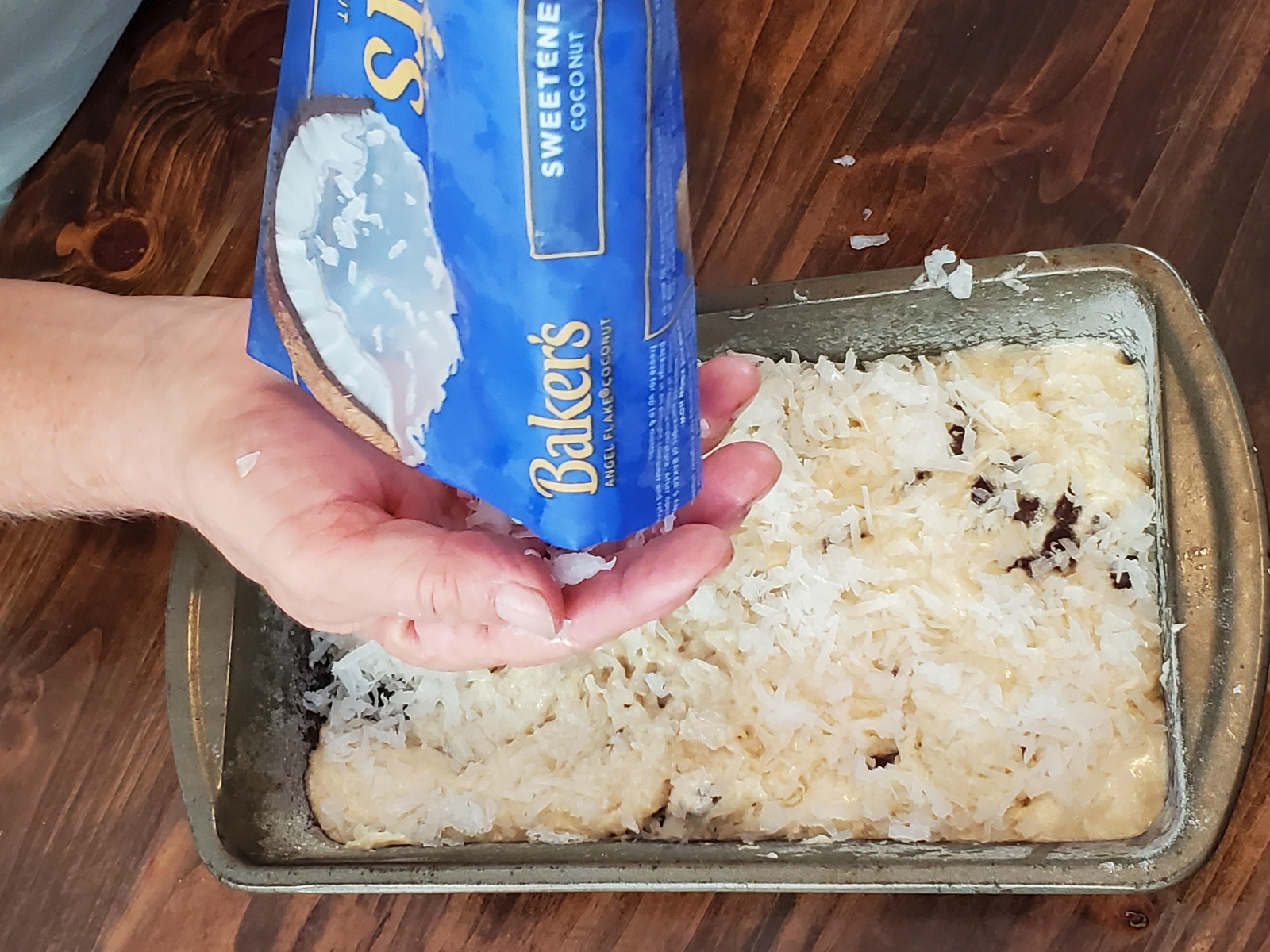 topping banana bread with chocolate chips and coconut