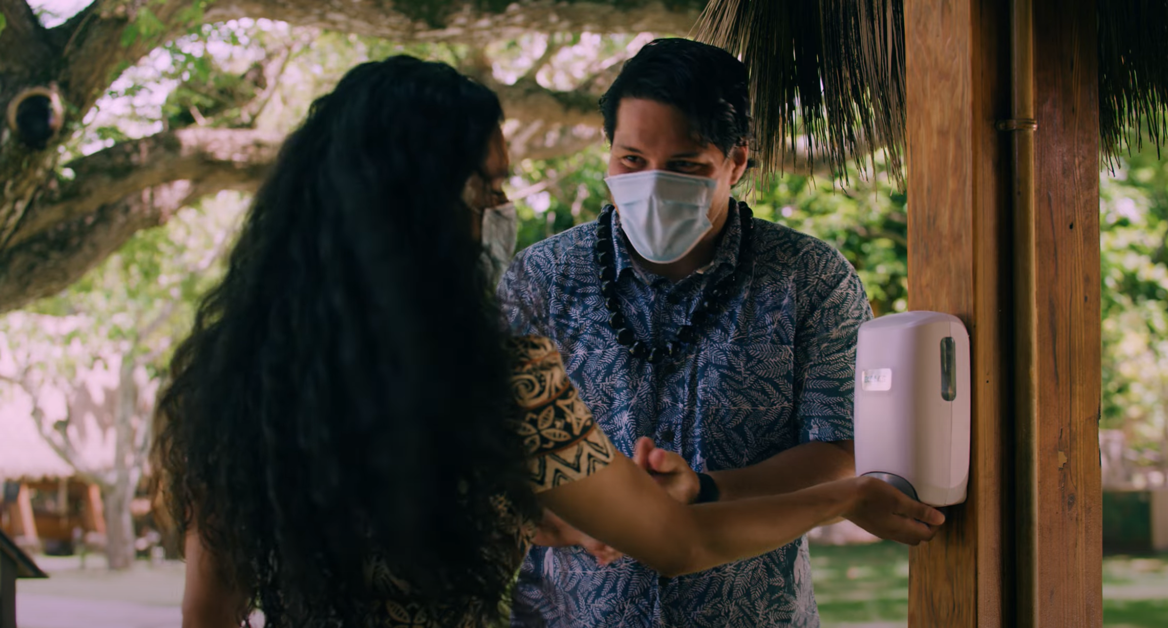 Two people at the Polynesian Cultural Center utilizes on of the hand sanitizing stations. The Center plans to fully reopen in March, 2021.