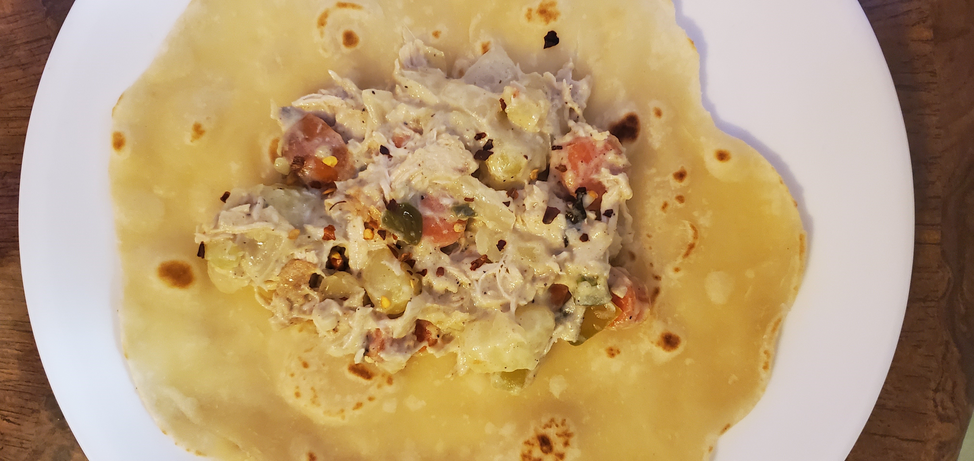 Chicken curry on a roti ready to roll