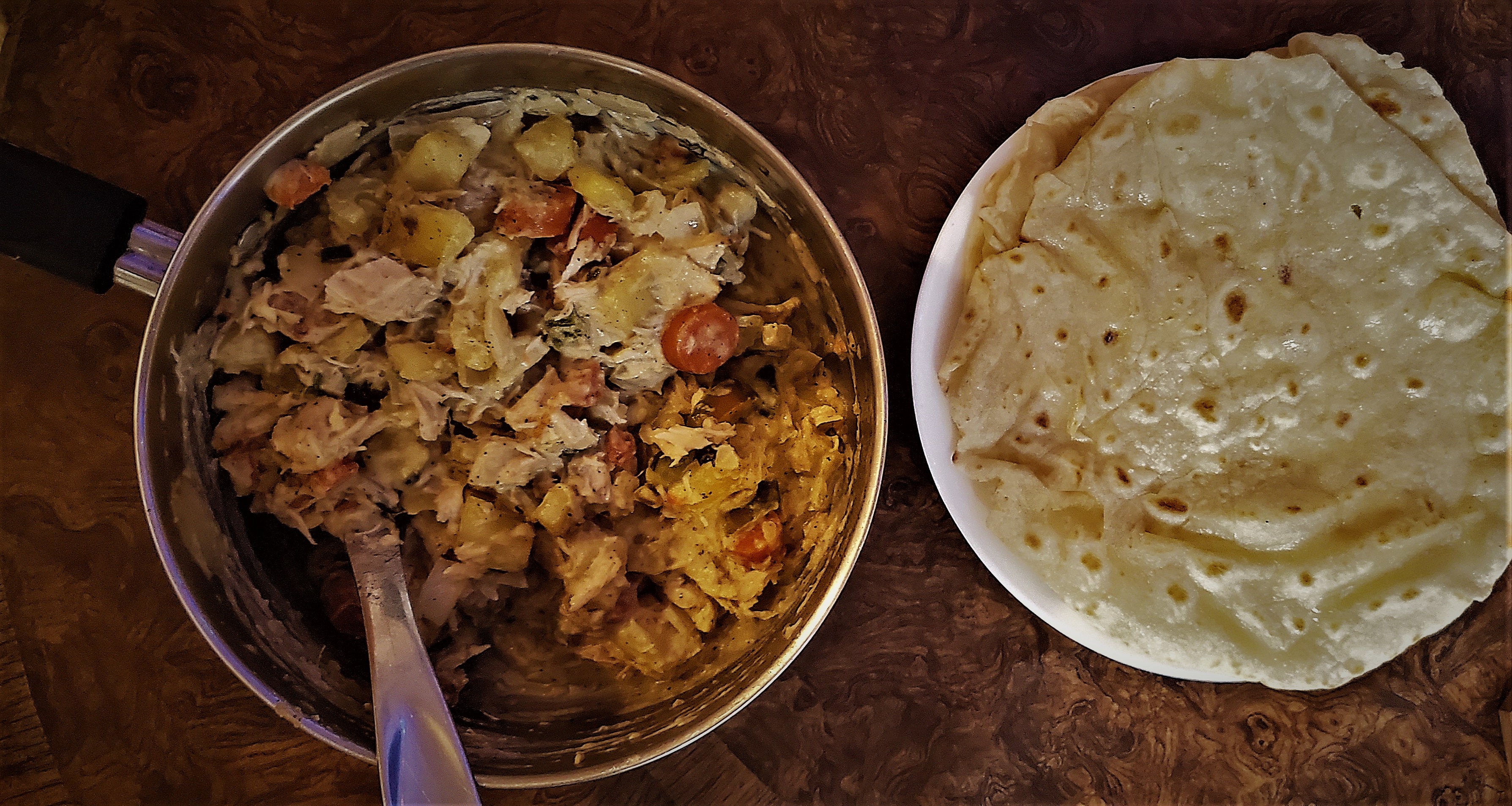 Photograph of chicken curry and prepared roti