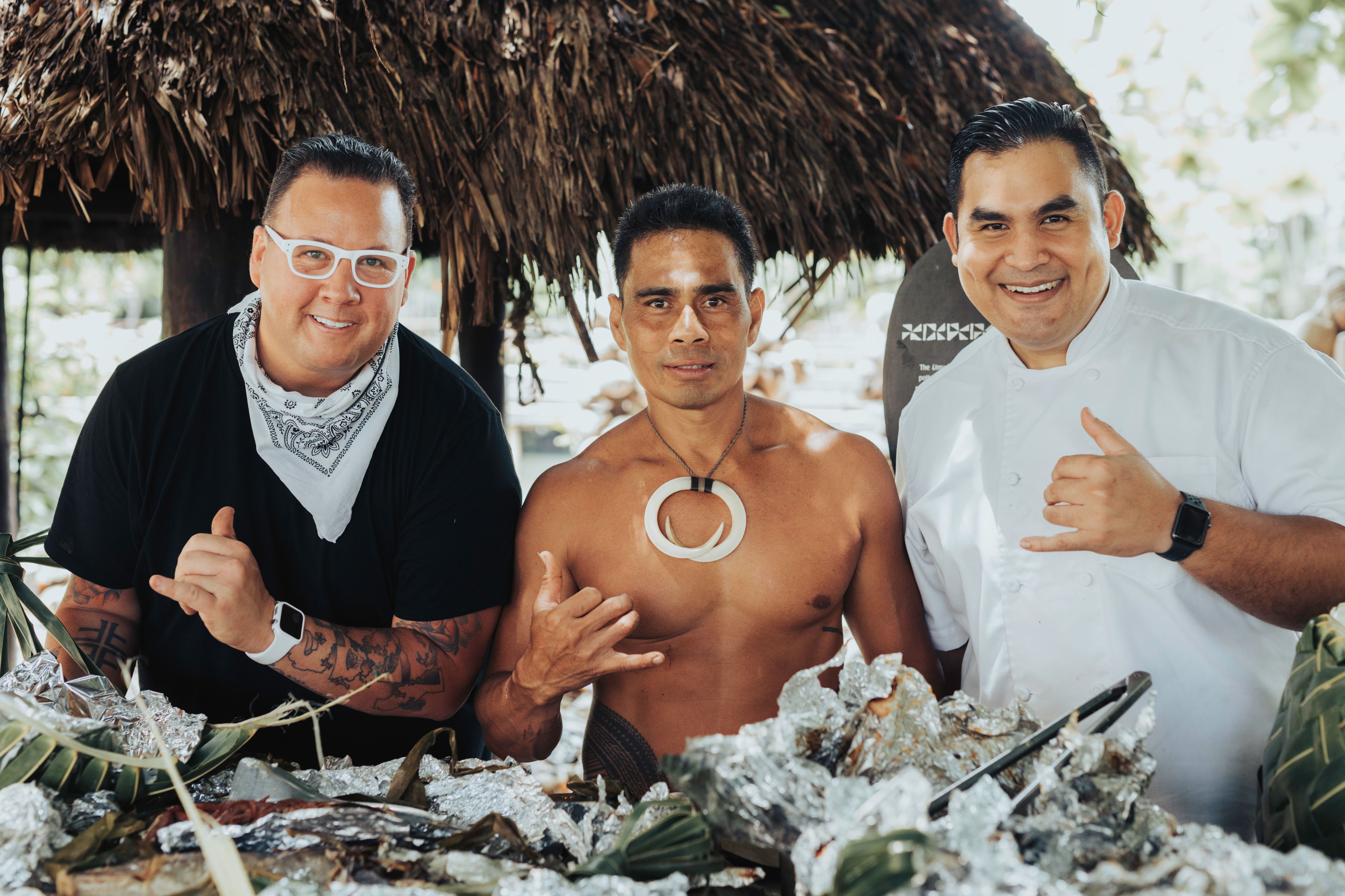 photo of three men at a Samoan cookout at the Islands of Polynesia in the Polynesian Cultural Center