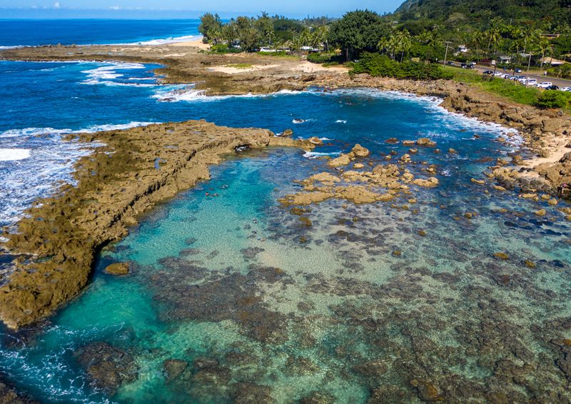 Aerial view of a blue lagoon and bay on the north shore of Oahu Hawaii we call Sharks Cove. Photo courtesy of www.snorkelplanet.com