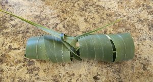 Tahitian coconut bread wrapped in coconut fronds 