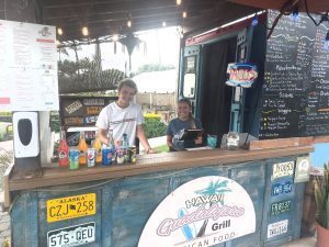 image of the Guadalajara Grill food truck with two employees posing