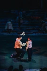 Man giving his son a symbolic birthday present that has been passed down through generations.