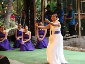 Image of a beautiful young lady showcasing the Hawaiian word Mahalo through her mesmerizing hula movements