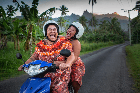 Two Cook island Women on a moped