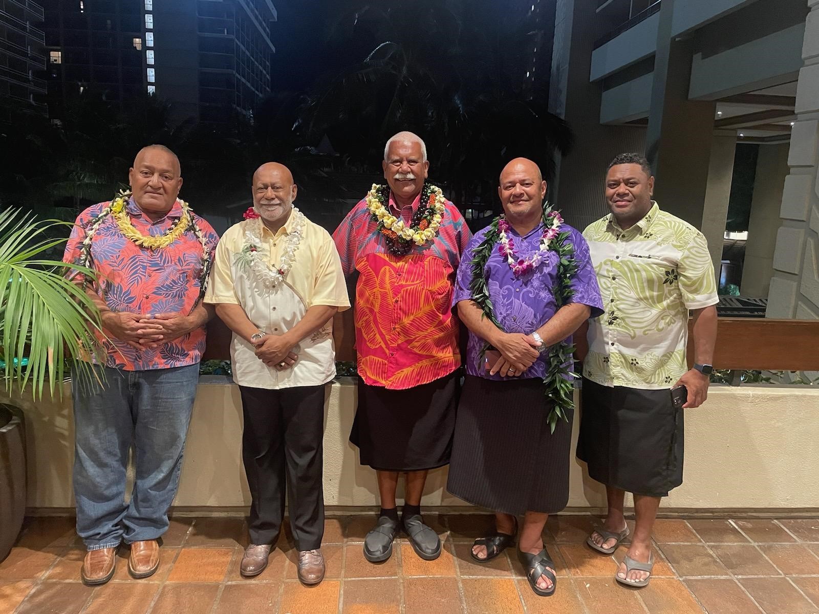 Group of men smiling at the Hilton Village