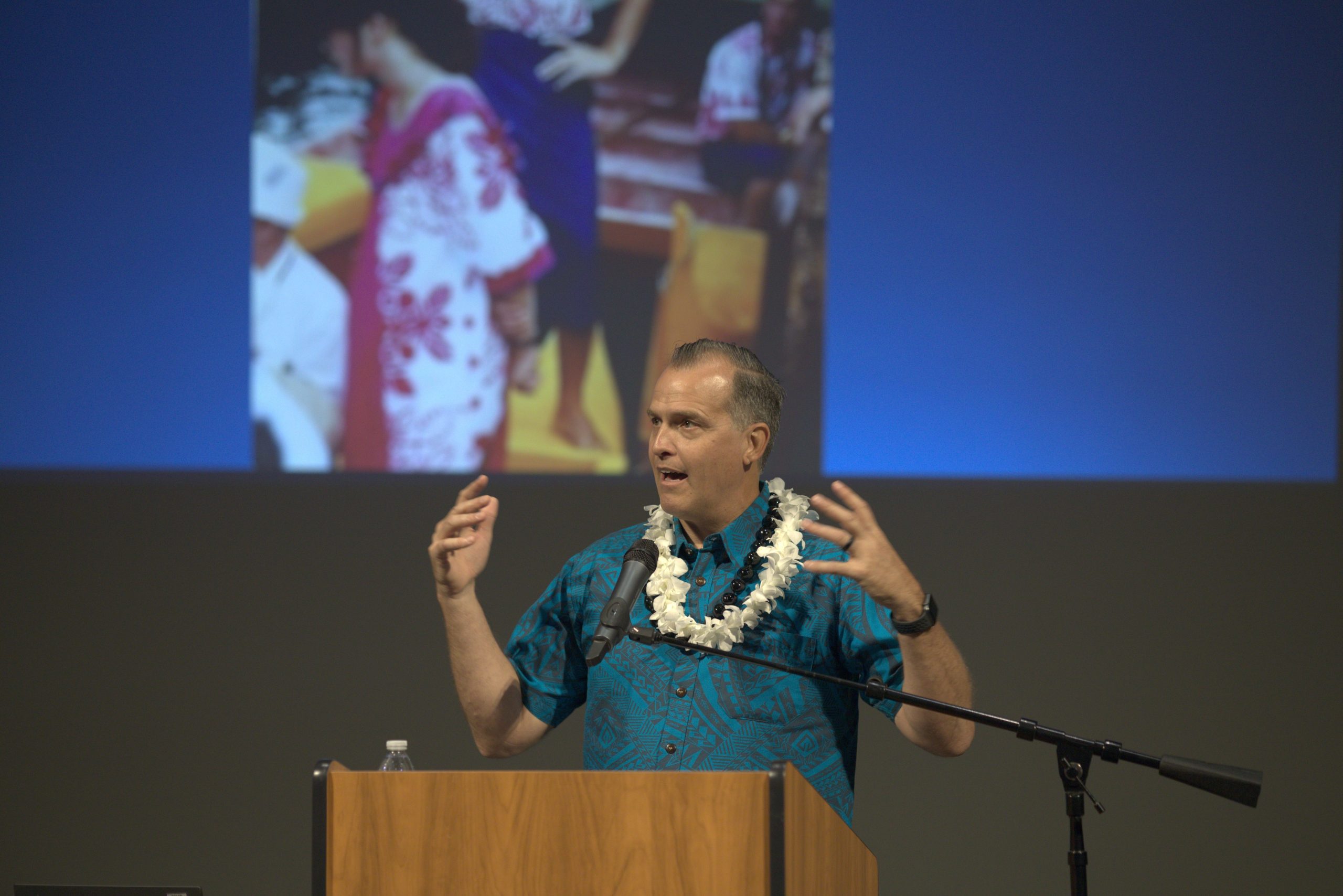 Aaron Shumway speaking at a pulpit